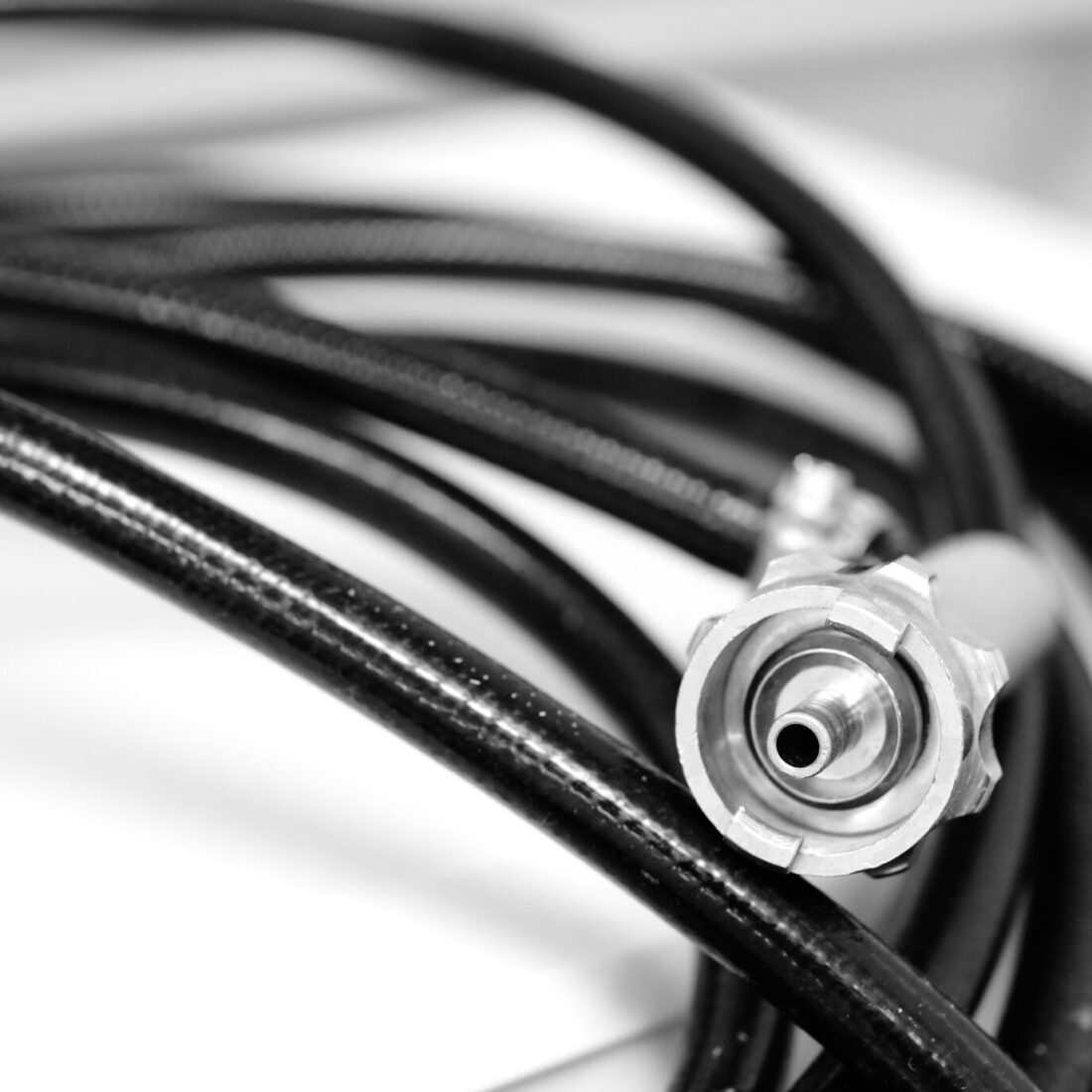 .abstract black and white photo with a metal connector tubes